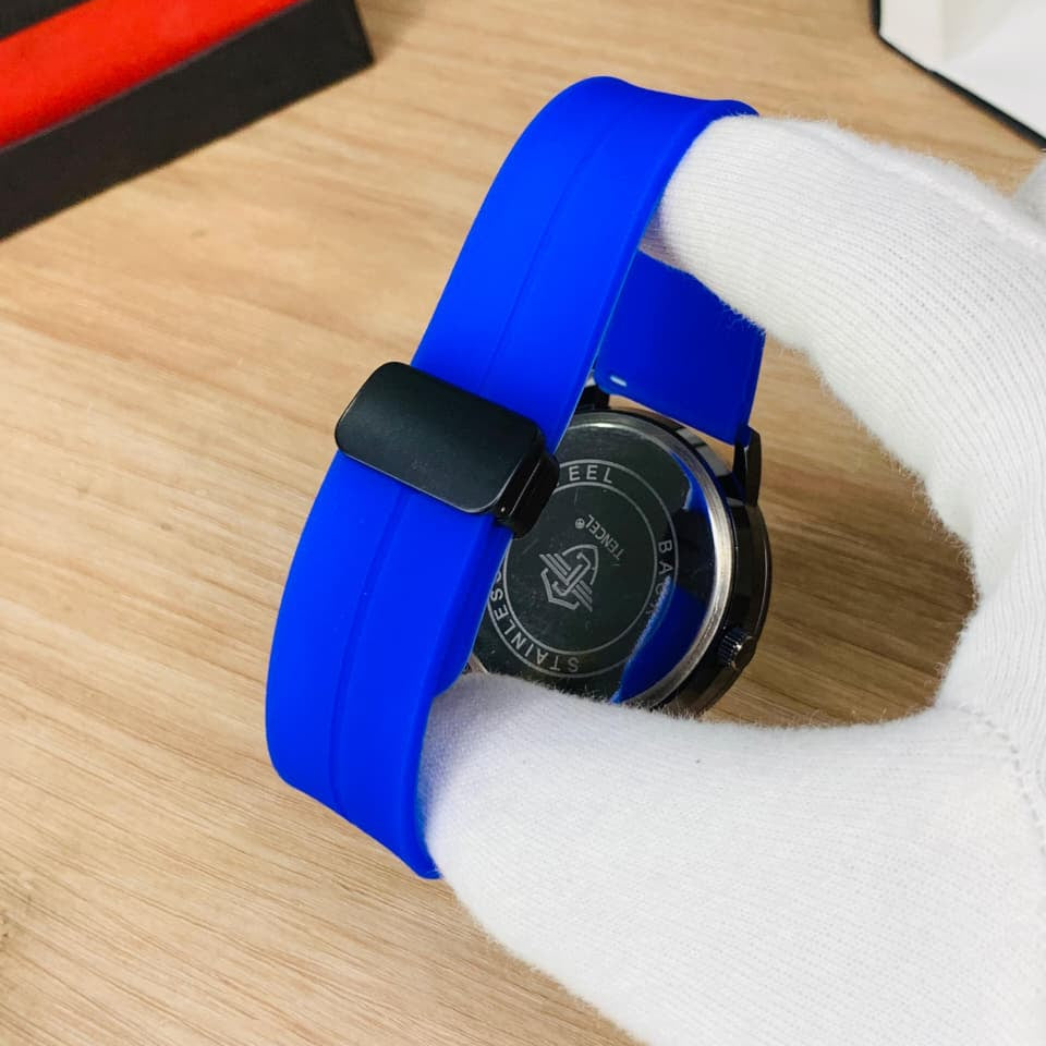 Watch with a blue strap on a wooden surface